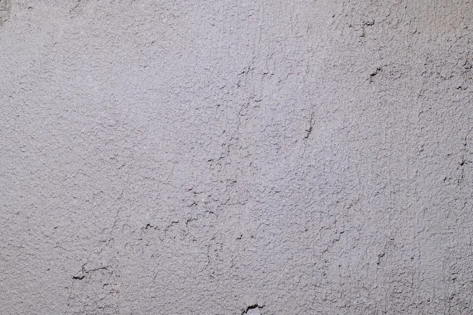 Grijs gestuukte muur met haarscheurtjes